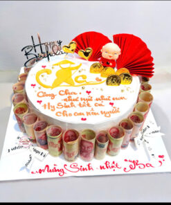 Bánh kem tặng ba dán tiền với tiền cuộn quanh bánh và trang trí vàng tài lộc